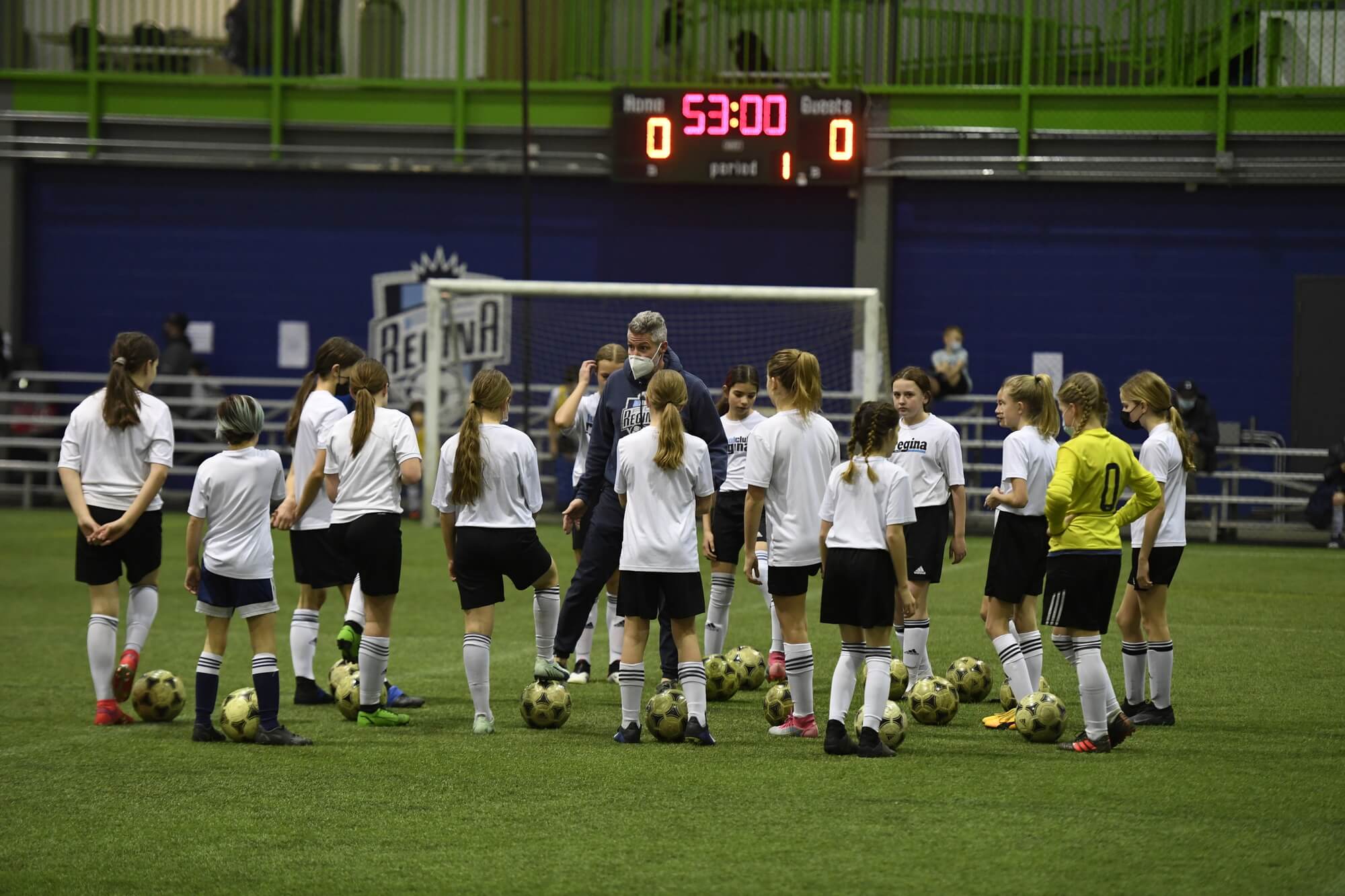A soccer team getting coaching on an indoor field, Regina, SK
