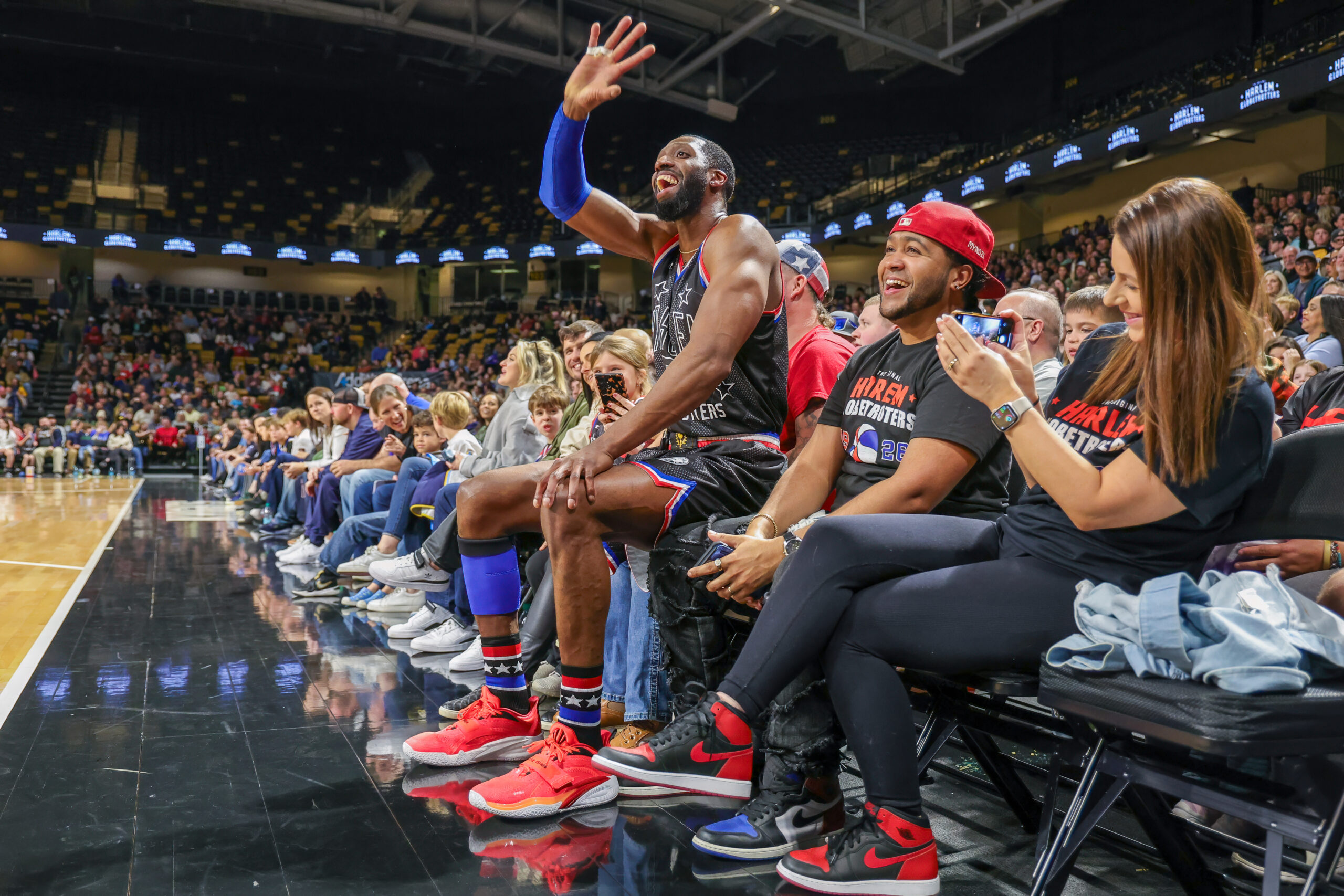 Basketball player entertaining audience at game.
