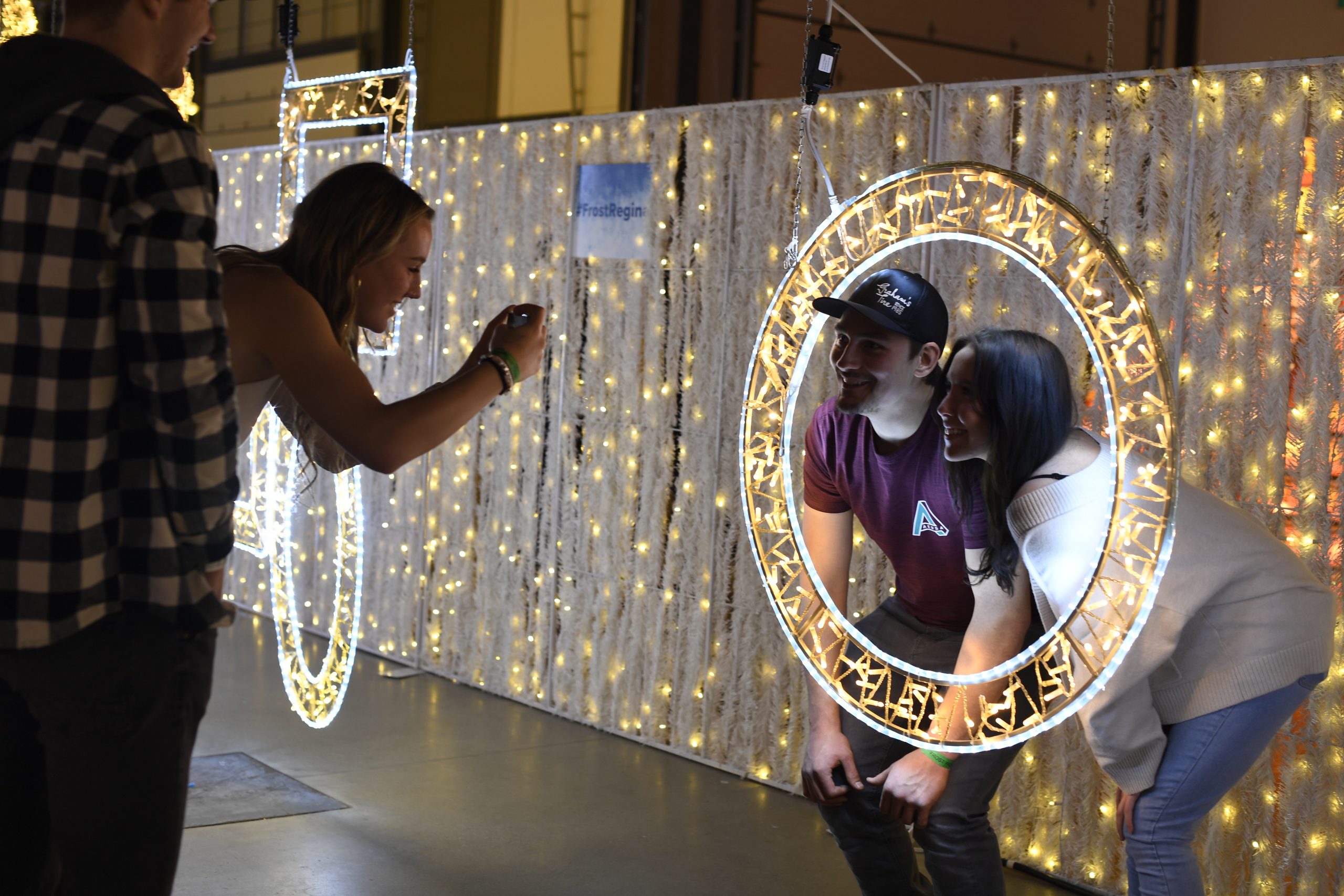 Friends taking photos with illuminated frames.