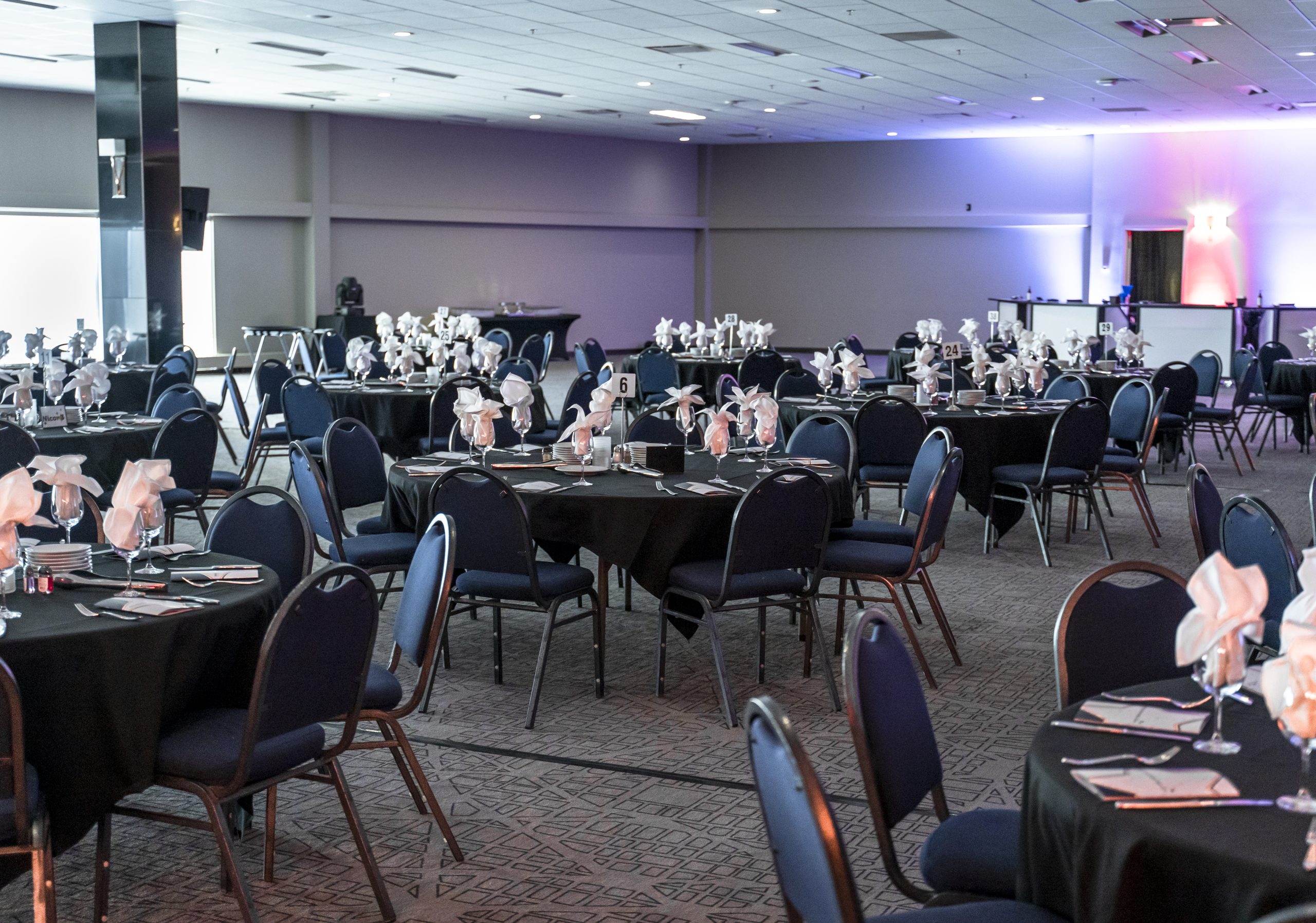 Elegant banquet hall with decorated tables and chairs.
