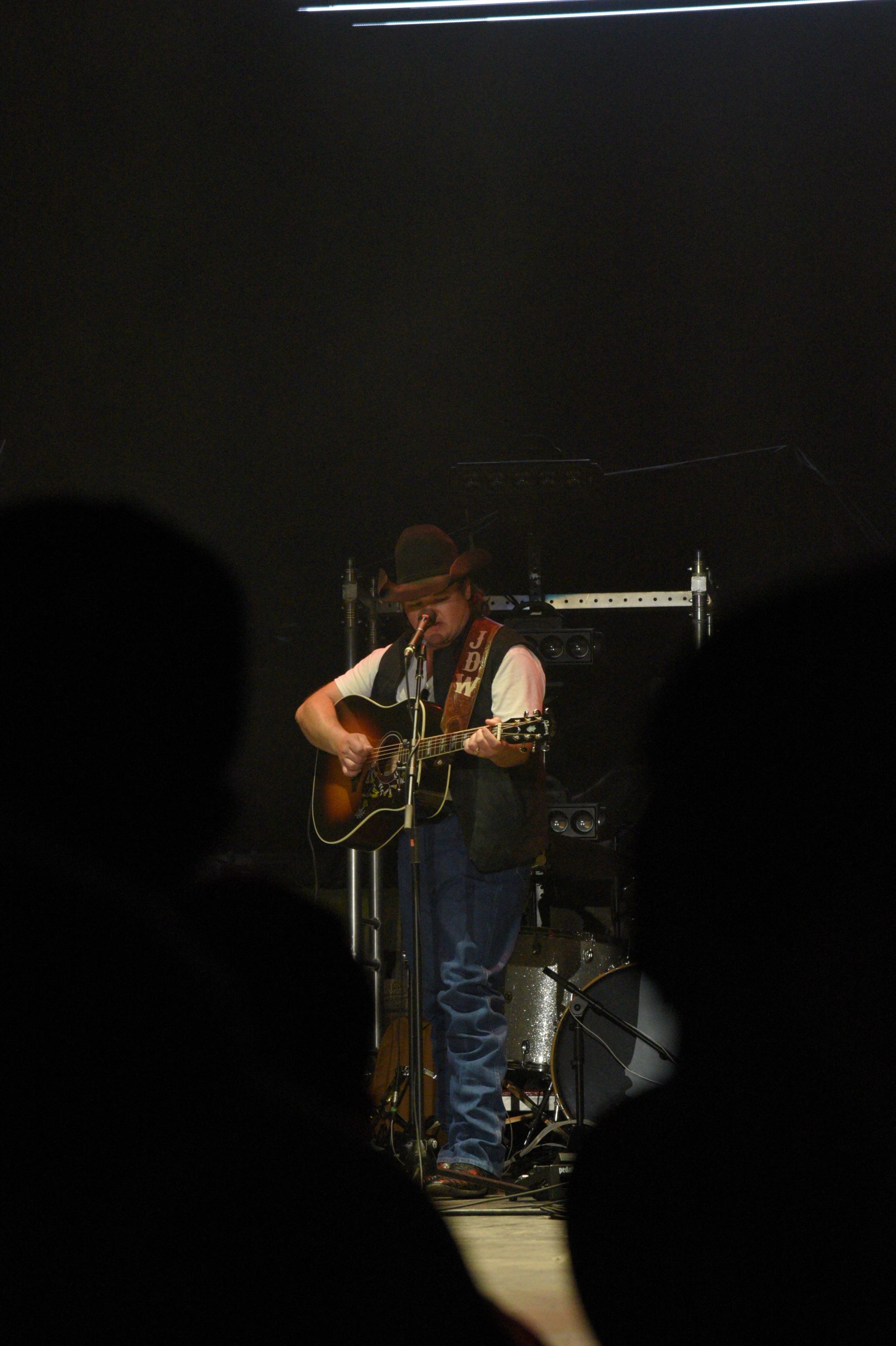 Country musician playing guitar on stage