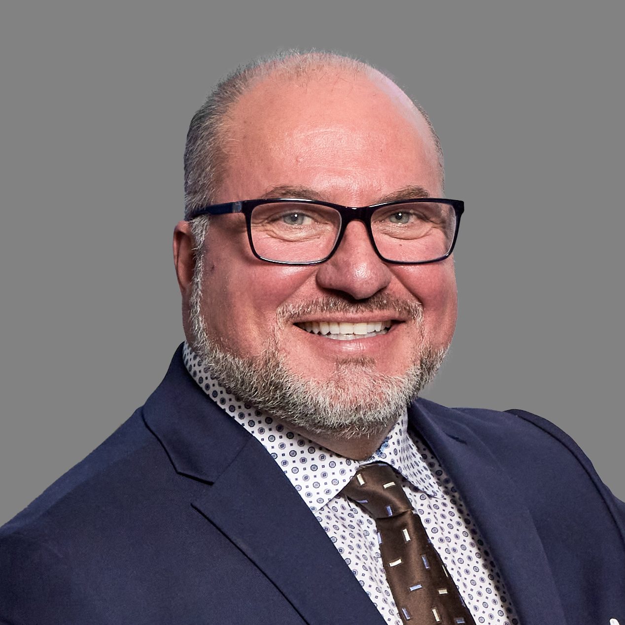 Smiling man in suit and glasses