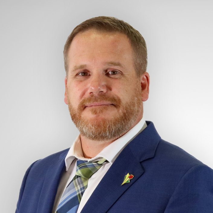 Man in suit with beard and tie.
