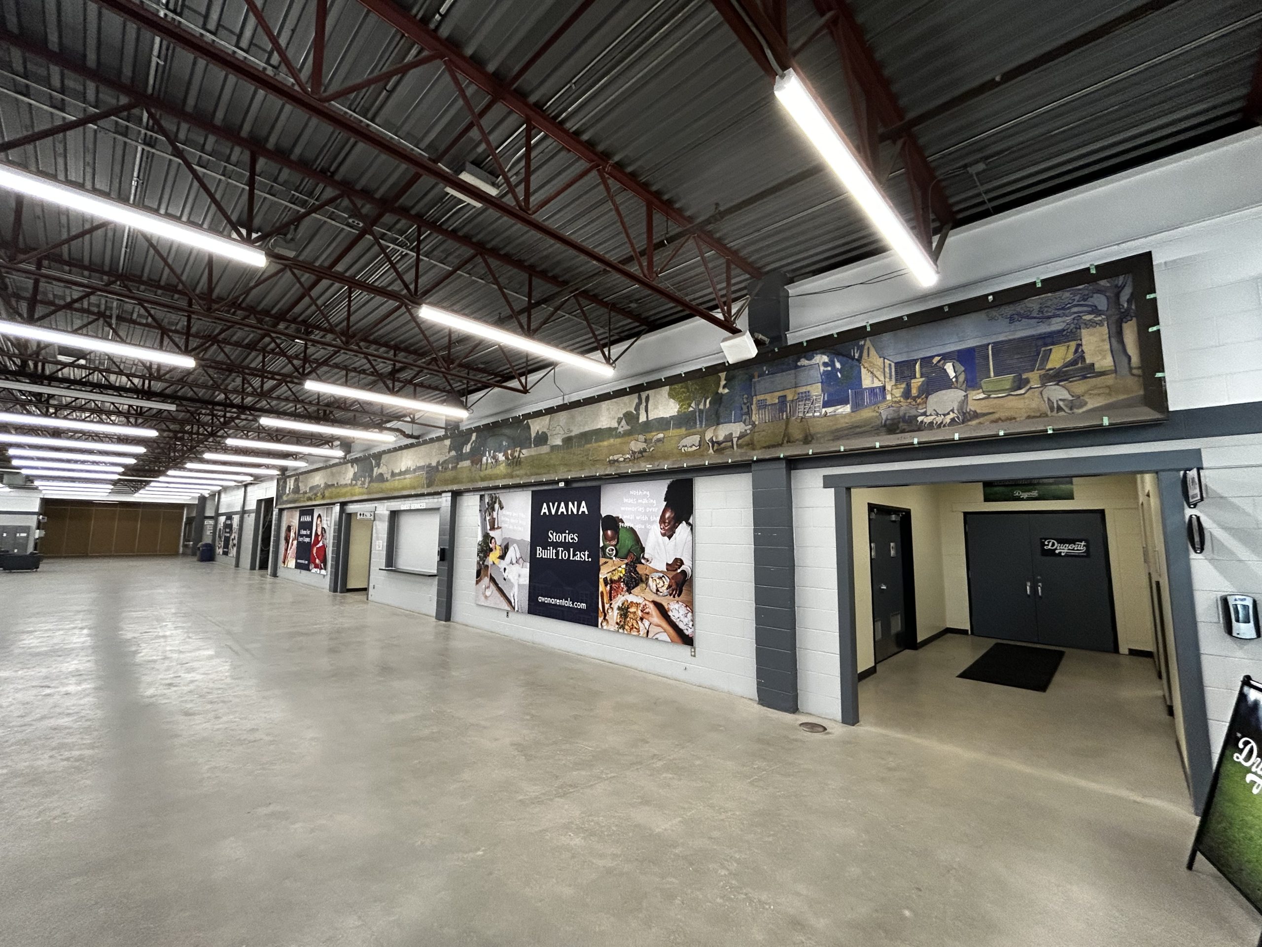 Spacious interior hallway with wall advertisements.