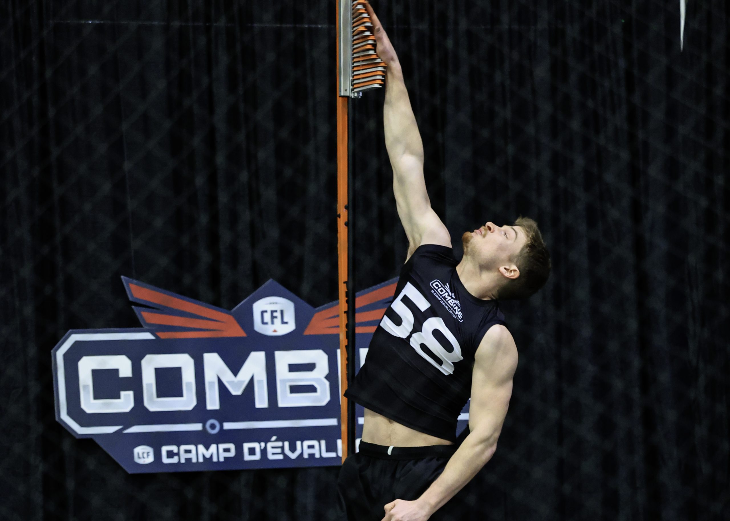 Athlete performing vertical jump at CFL combine.