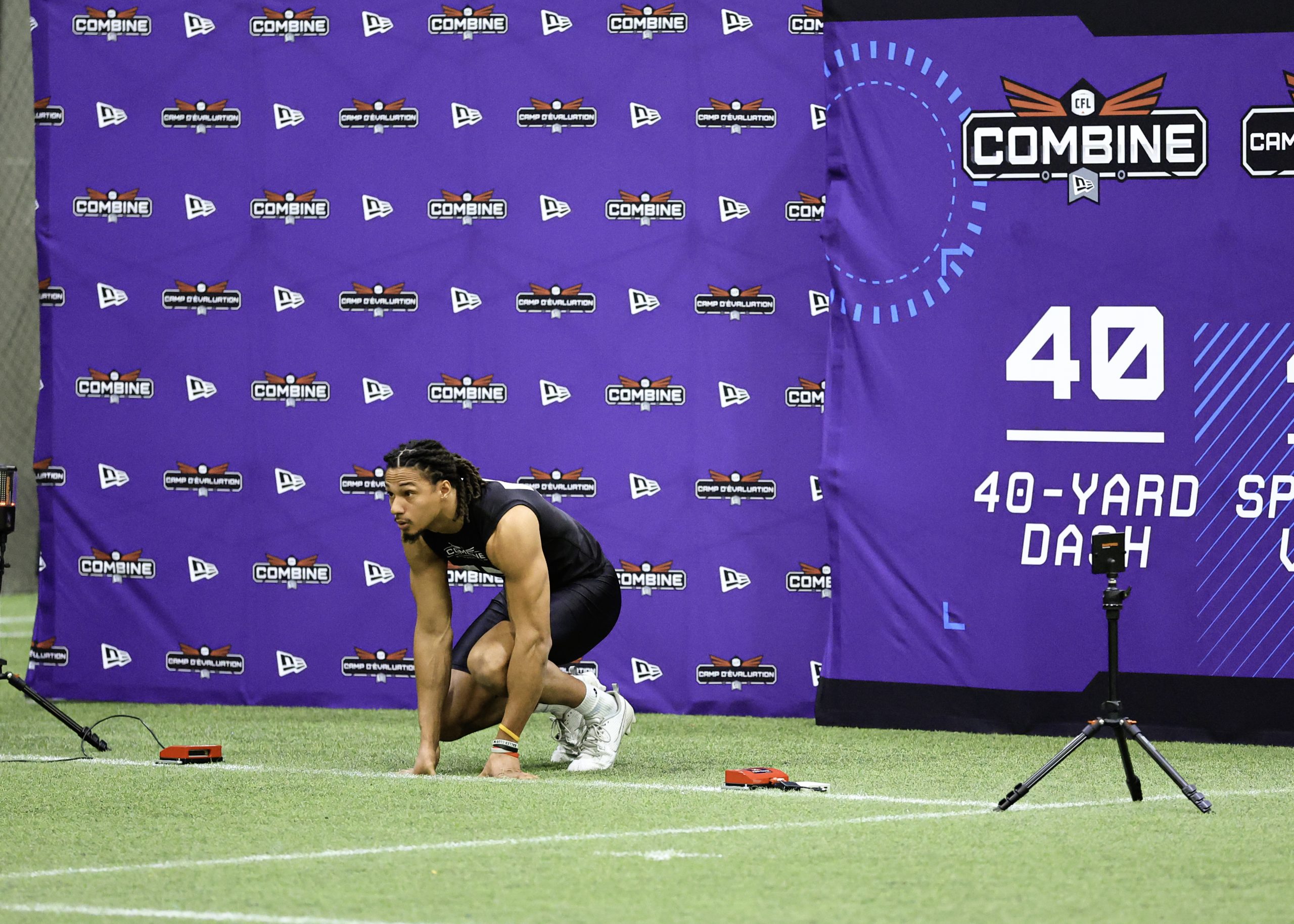 Athlete preparing for 40-yard dash at combine.
