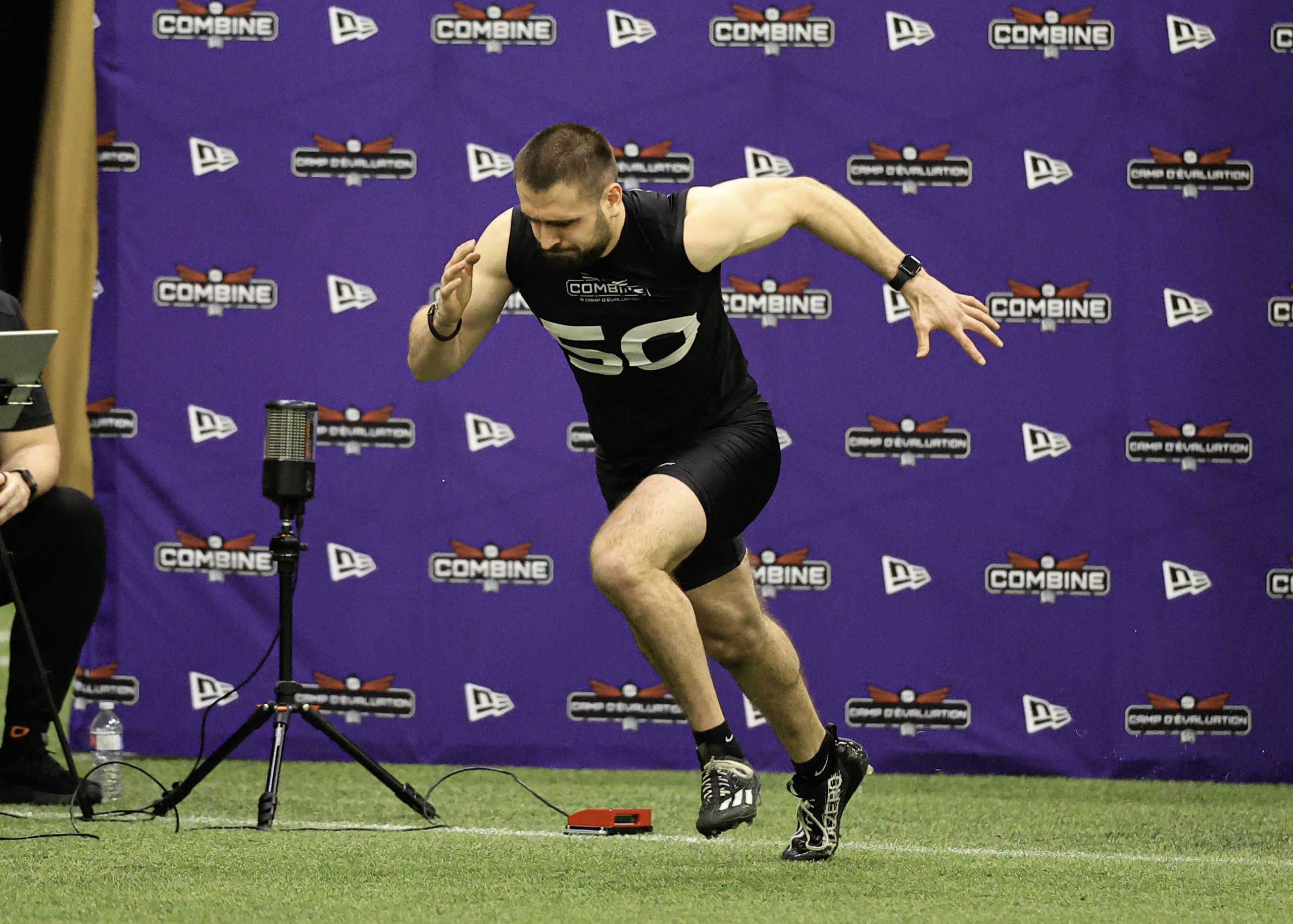 Athlete sprinting at football combine event.