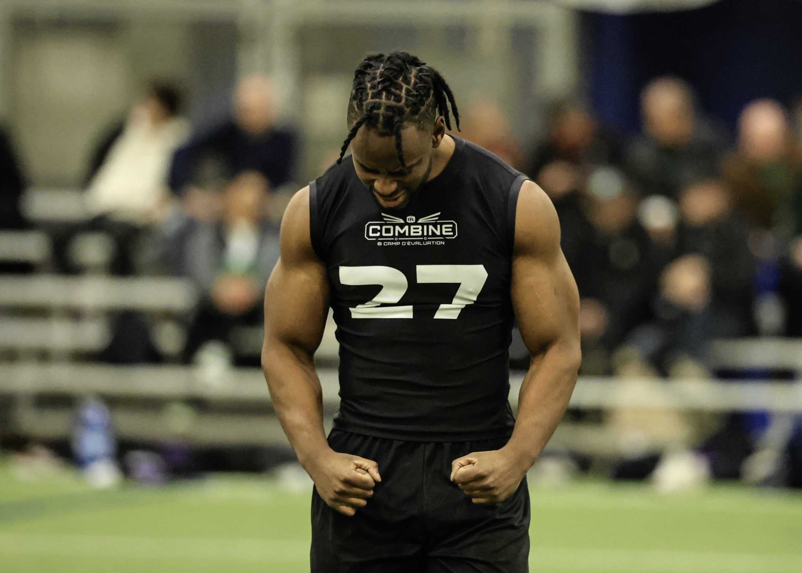 Athlete at fitness evaluation event, wearing number 27 shirt.