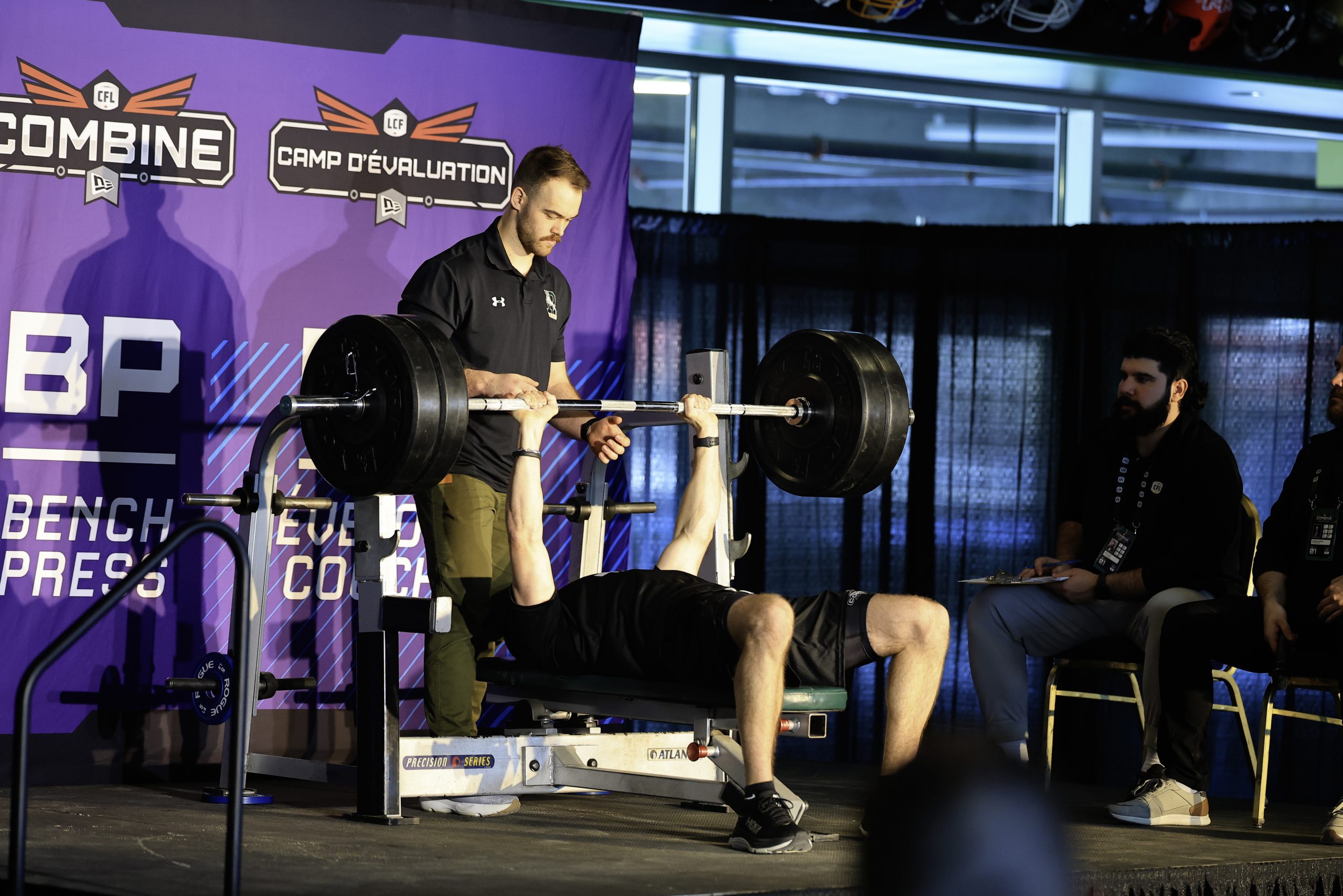 Athlete bench pressing at CFL Combine event.