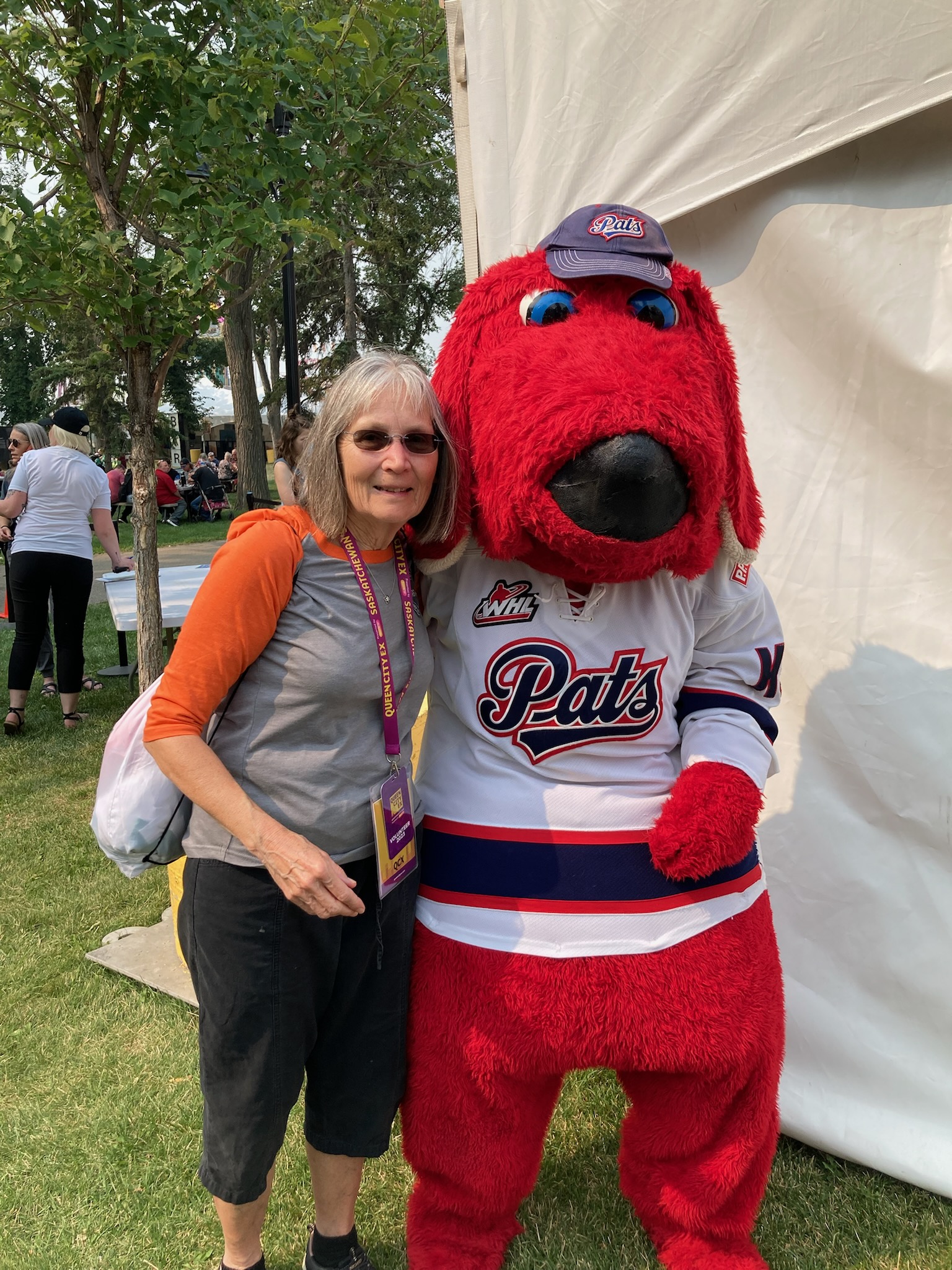 Woman with red sports mascot outdoors