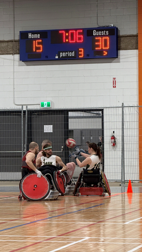 Wheelchair basketball game in action, scoreboard shows 15-30.