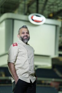 Smiling chef in kitchen setting.
