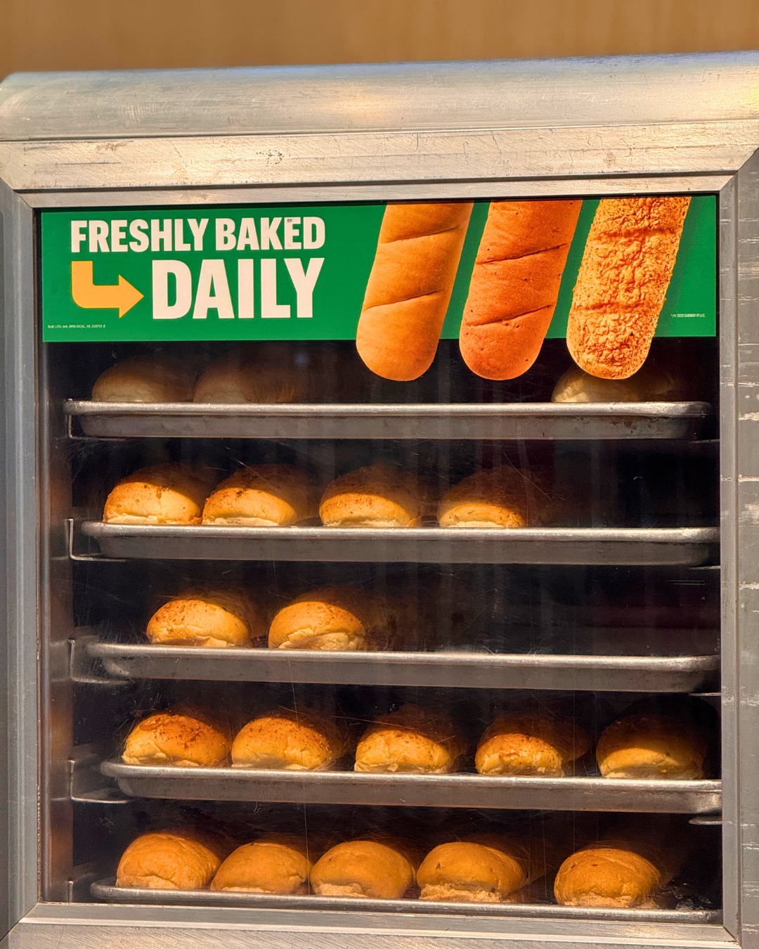 Freshly baked bread rolls in trays, daily