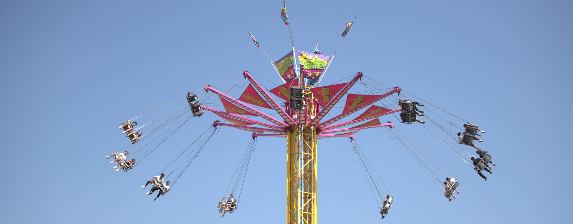 Colorful amusement park ride against blue sky